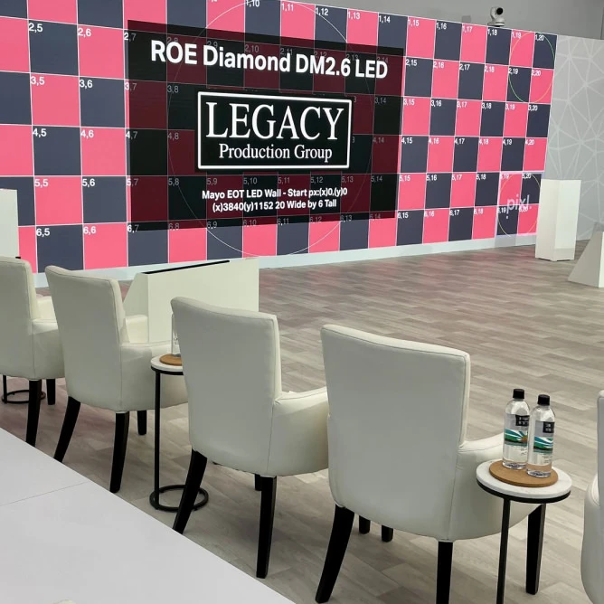 Ice Rink LED video wall showing a pink-and-gray numbered calibration grid with ‘LEGACY Production Group’ branding; 